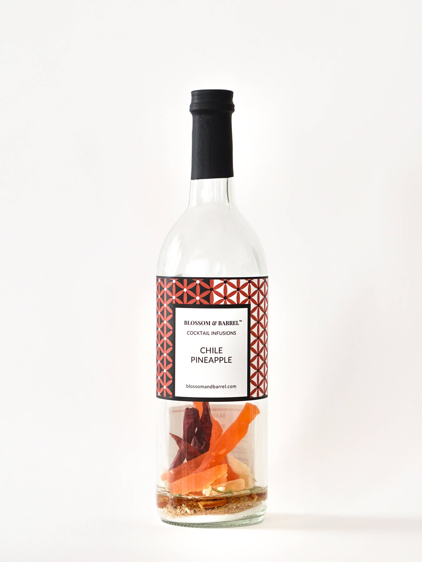 Bottle of Chile Pineapple cocktail infusion with a decorative label on a white background