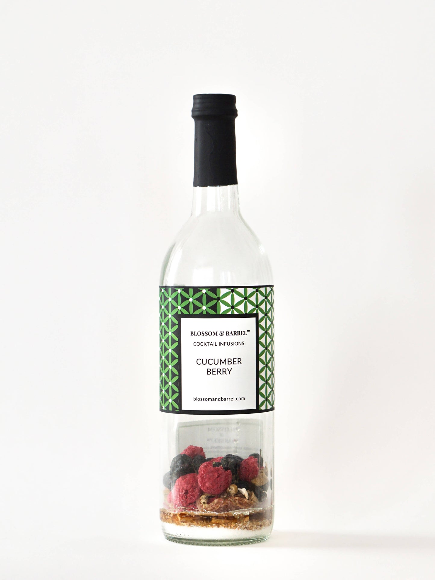 Bottle of Cucumber Berry cocktail infusion with a label on a white background