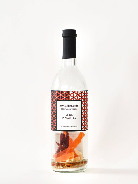Bottle of Chile Pineapple cocktail infusion with a decorative label on a white background