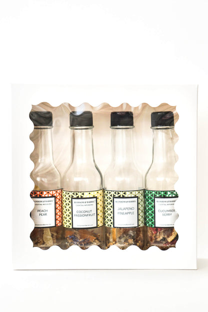 Set of four bottles with different flavors on a white background