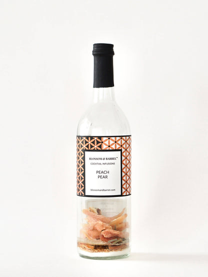 Bottle of 'Peach Pear' cocktail mixer with a decorative label on a white background
