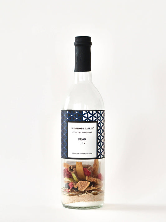 Bottle of pear fig cocktail infusion with a label on a white background
