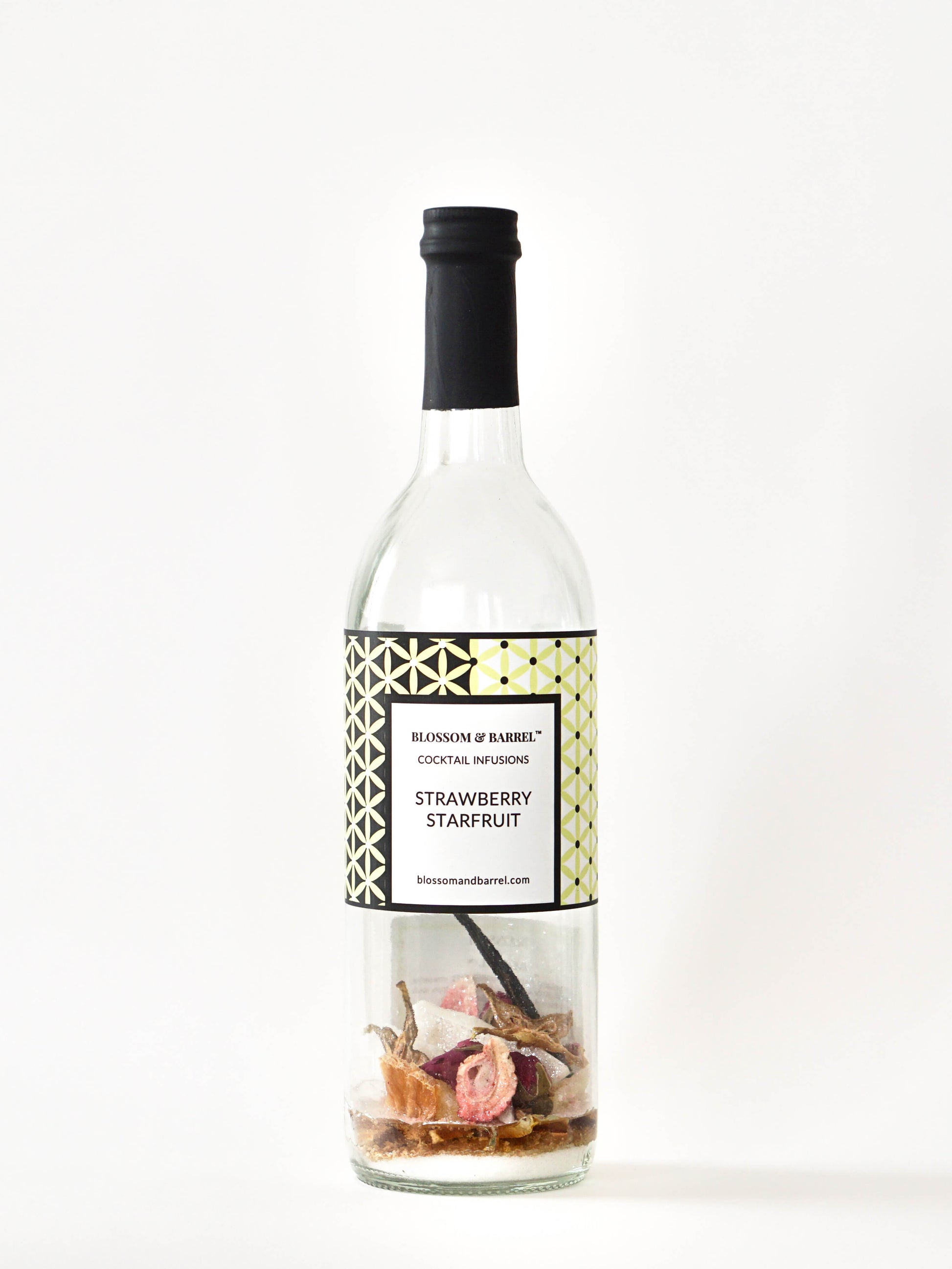 Bottle of strawberry starfruit cocktail infusion with a decorative label on a white background
