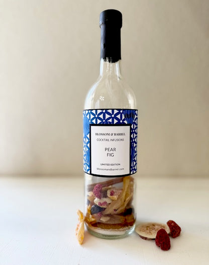 Bottle of Blossom & Barrel Pear Fig cocktail infusion on a white surface with a plain background
