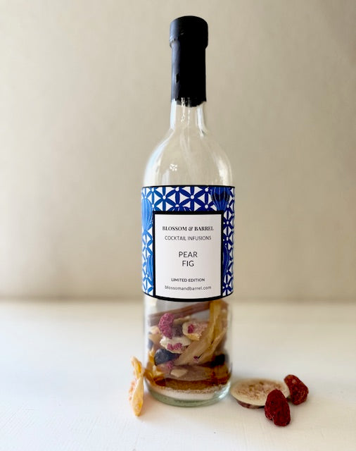 Bottle of Blossom & Barrel Pear Fig cocktail infusion on a white surface with a plain background
